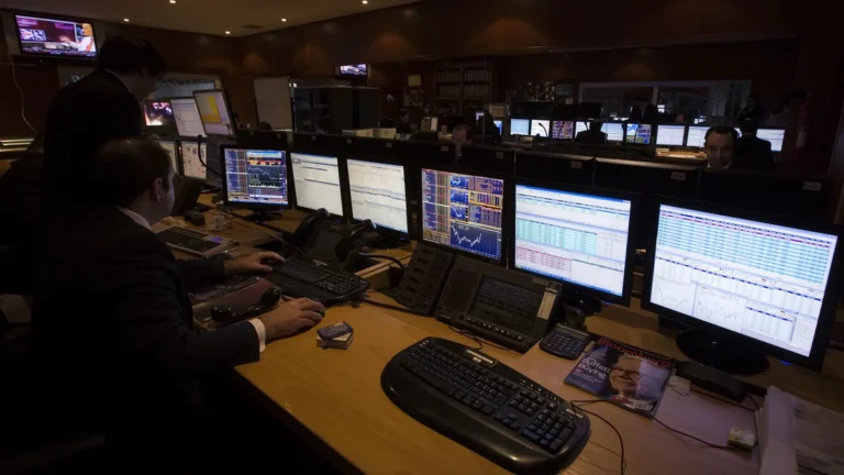 Professional trading desk with multiple monitors for prop firm EA risk planning